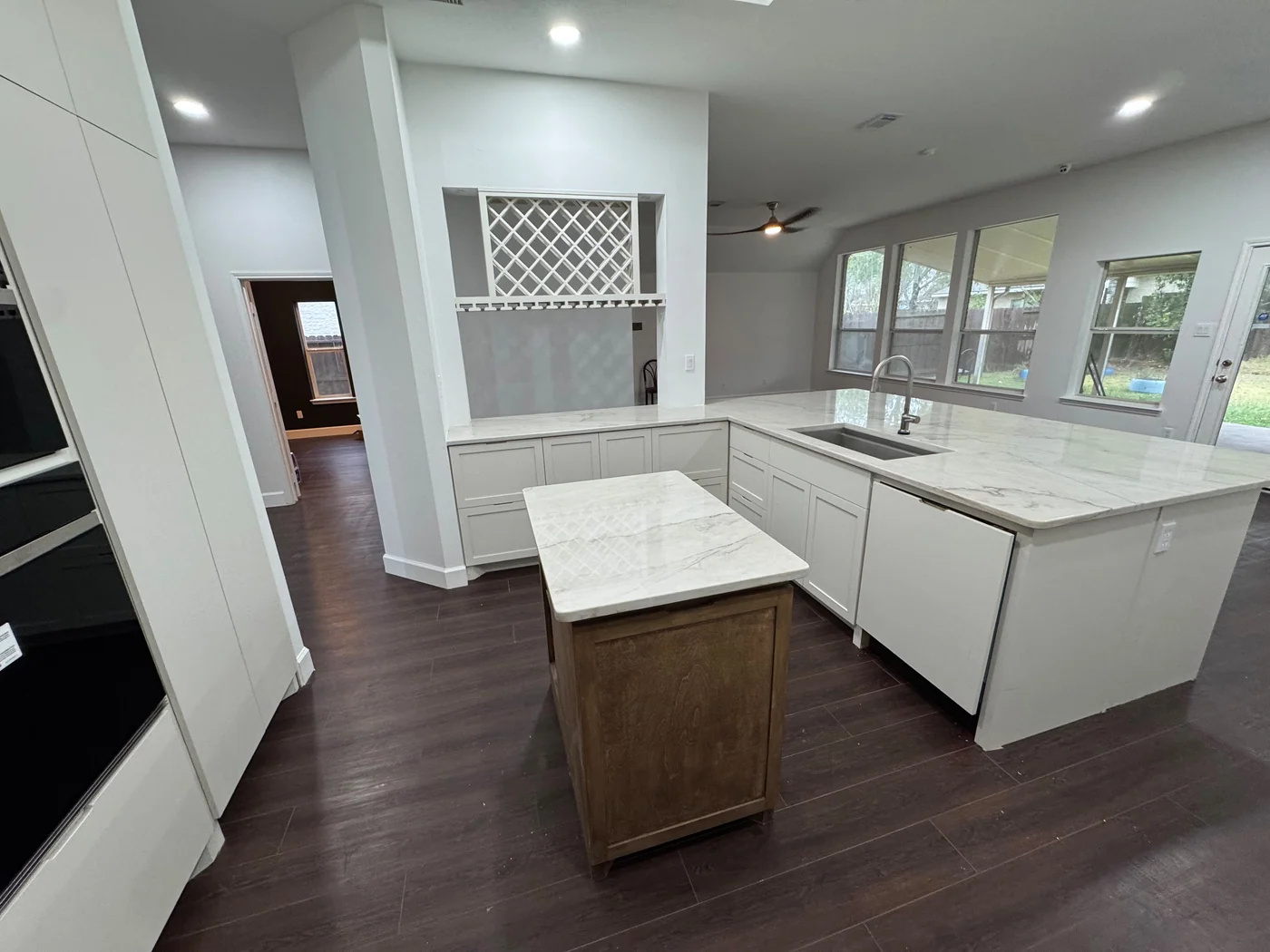 A Houston kitchen with dark cabinets reworked into an open white kitchen after the remodel