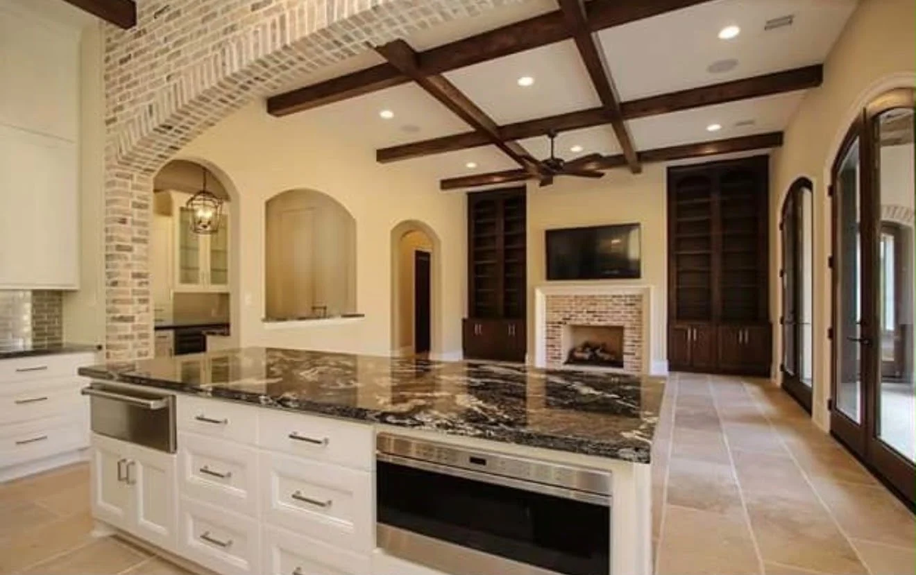 Kitchen remodel by LL General Contractor with a brick barrel ceiling, exposed beams and a granite island